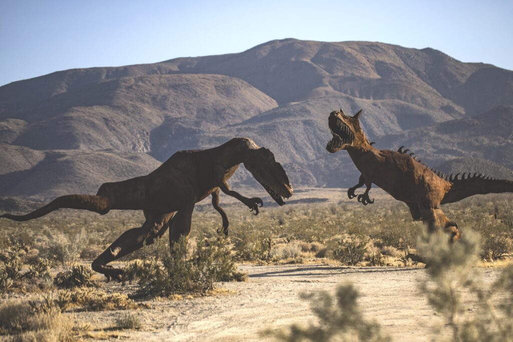 brown horse running on brown field during daytime