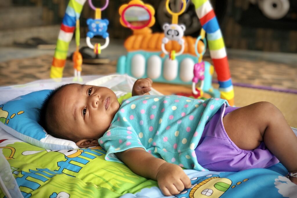 Baby playing with playgym