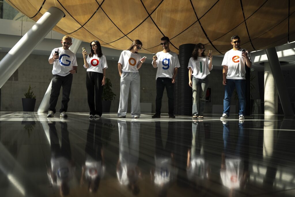 A group of people wearing t-shirts with letters